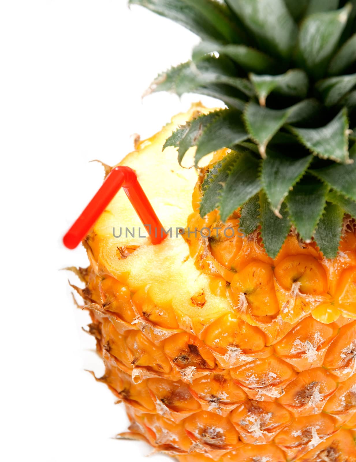 ripe vivid pineapple with red straw over white background