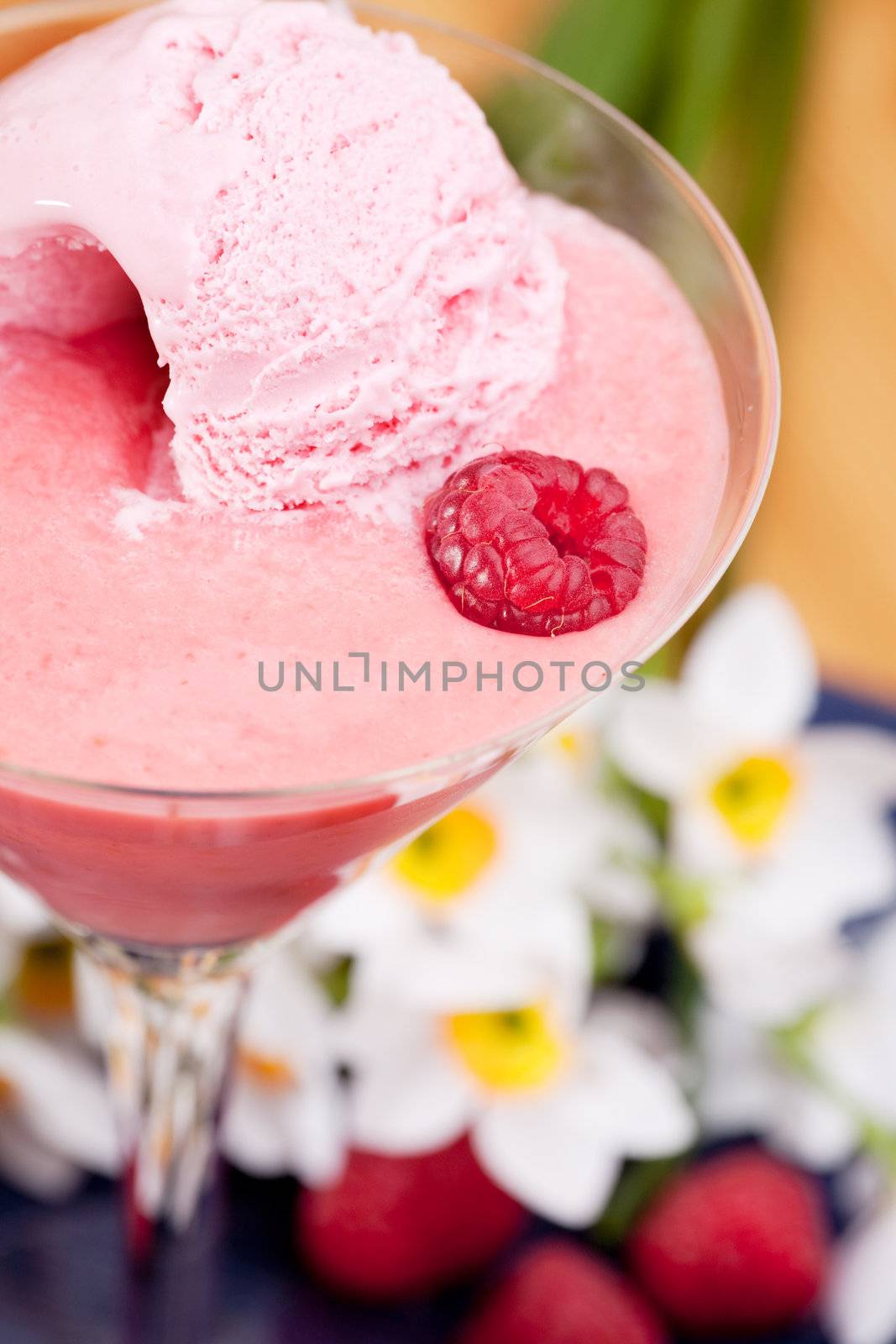A smoothie with ice cream and raspberries