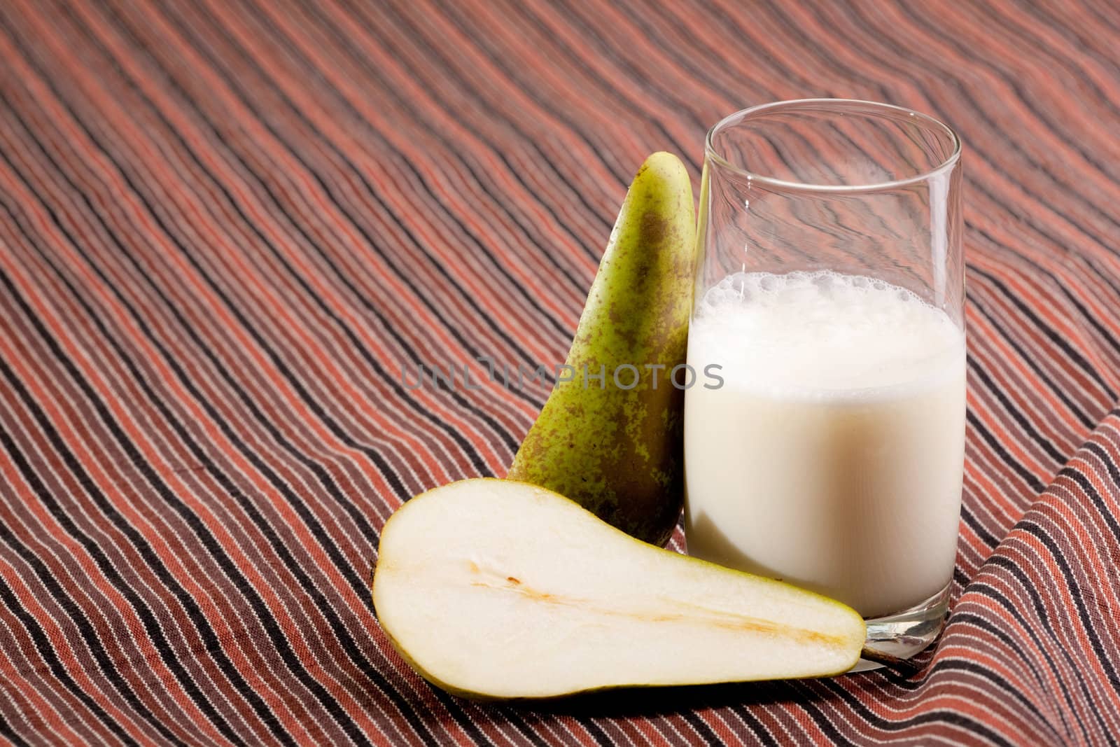 A pear smoothie on a stripped table cloth