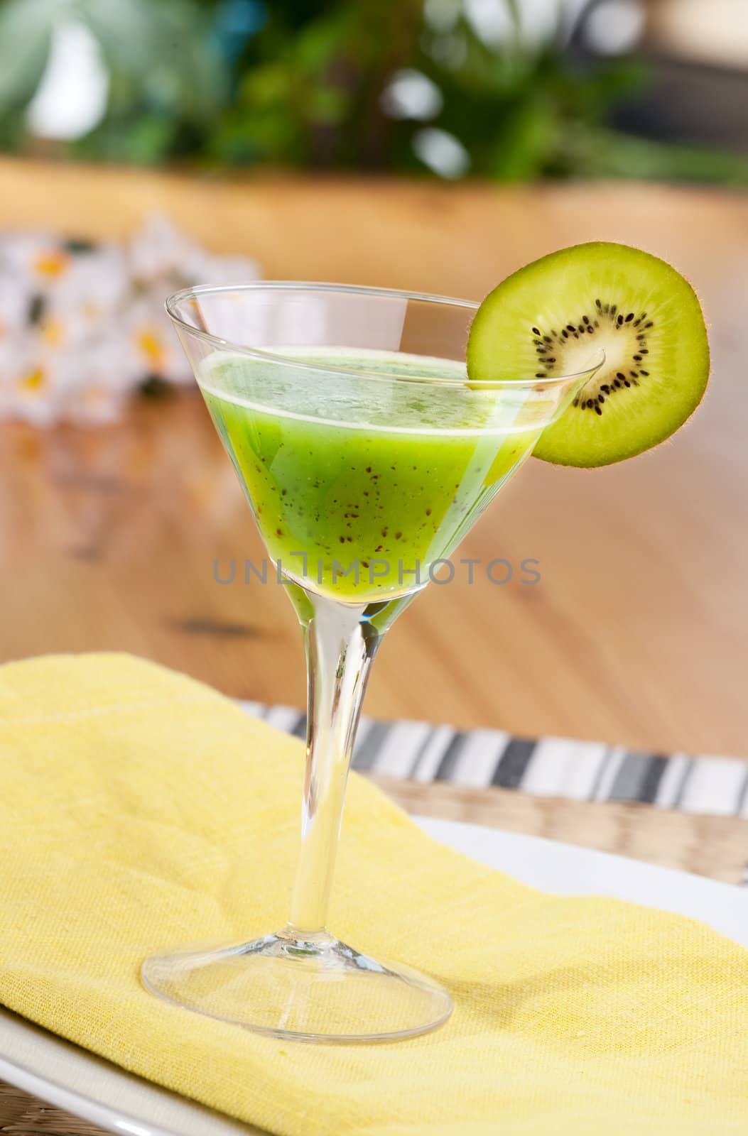 A kiwi based fruit drink in a martini glass