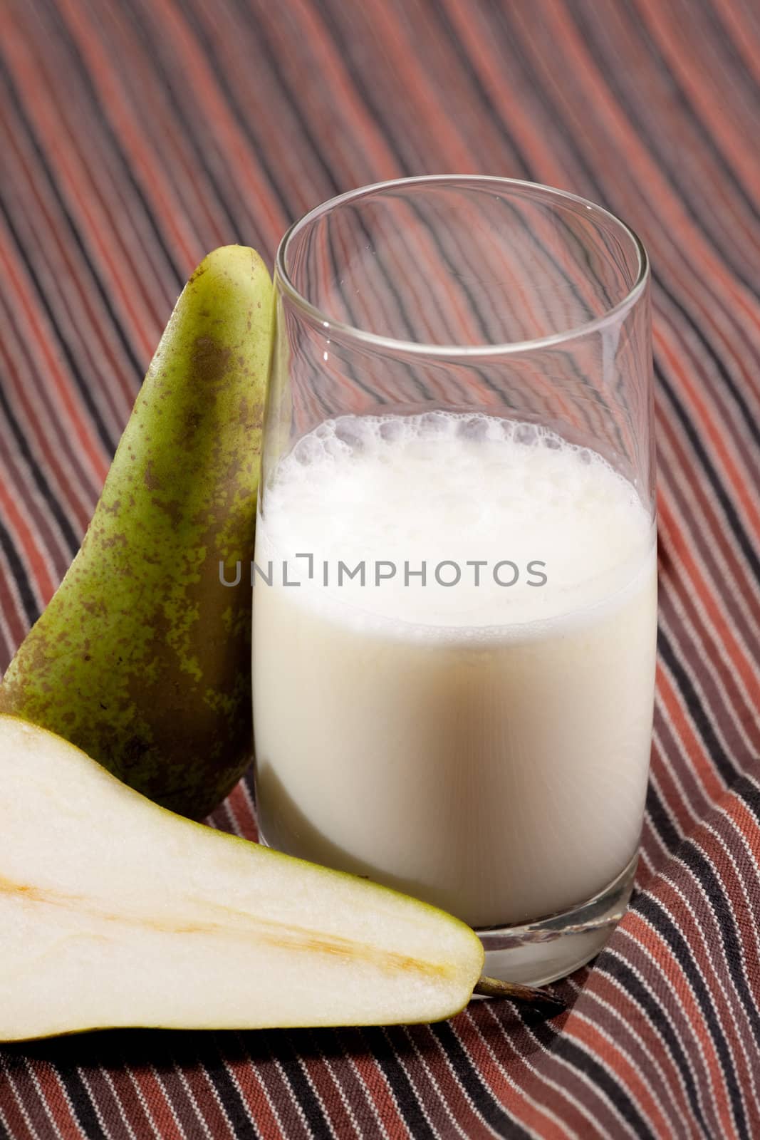 A pear smoothie on a stripped table cloth
