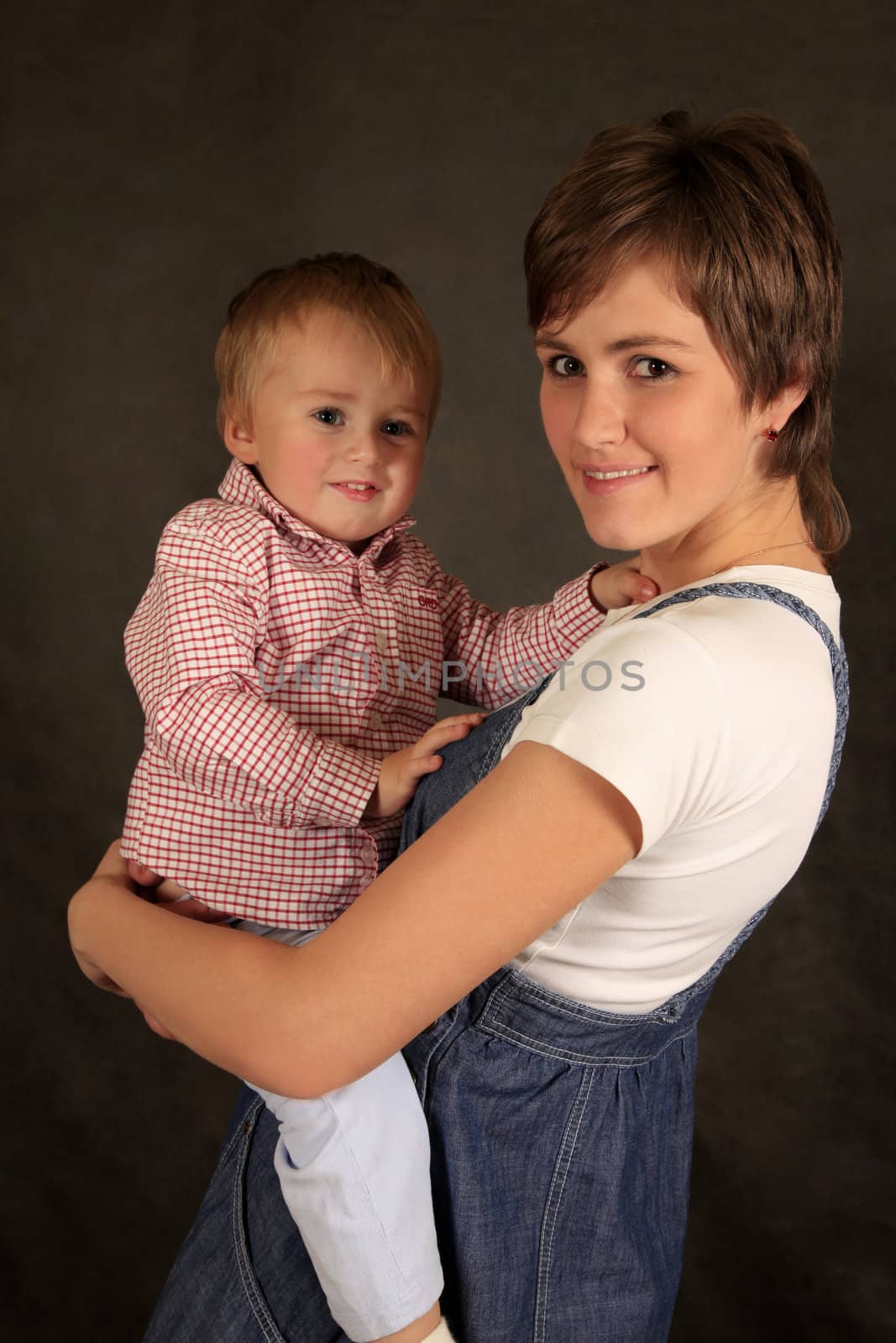 Picture of happy mother with baby in studio