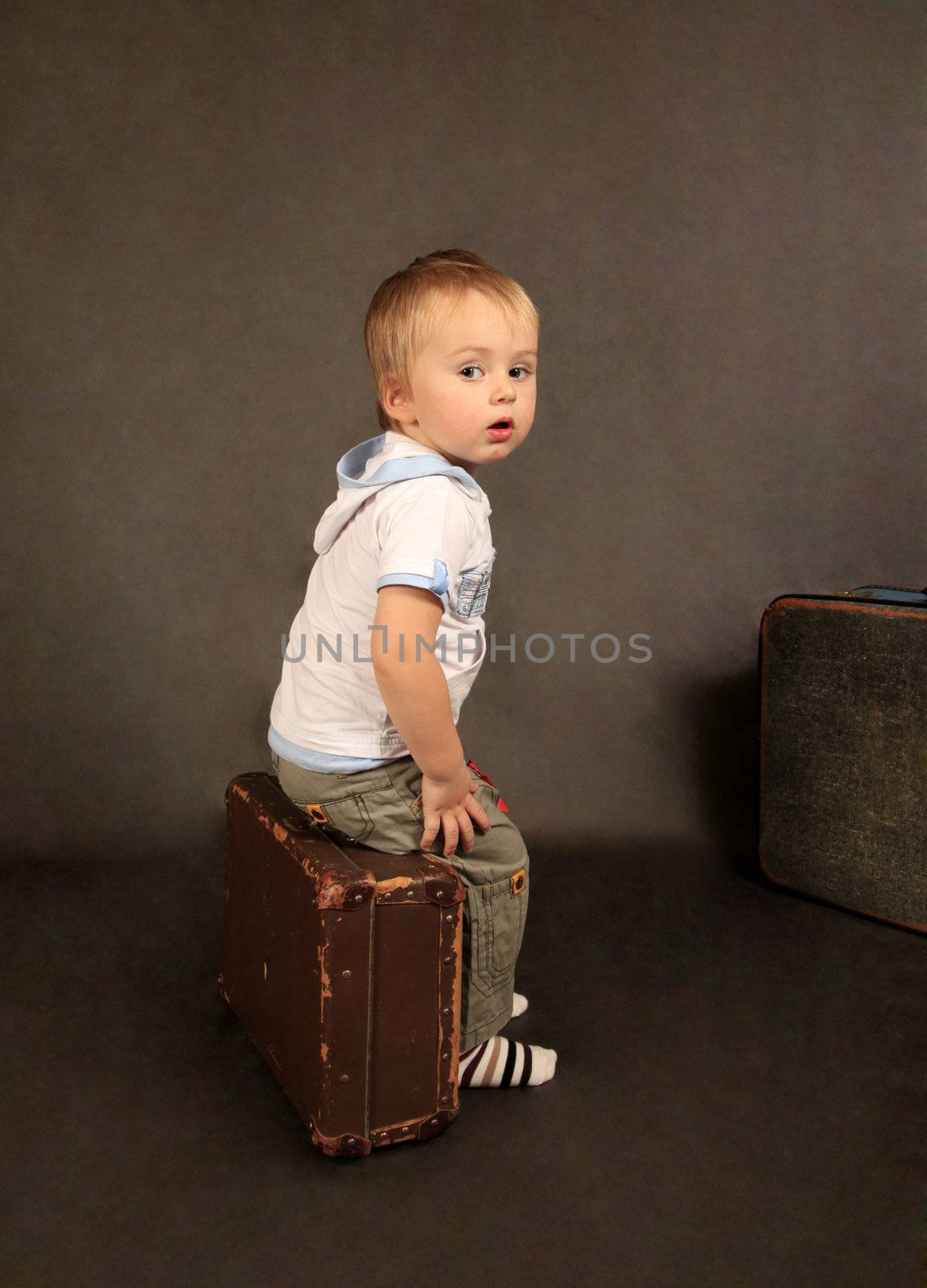 The little boy with two old suitcases