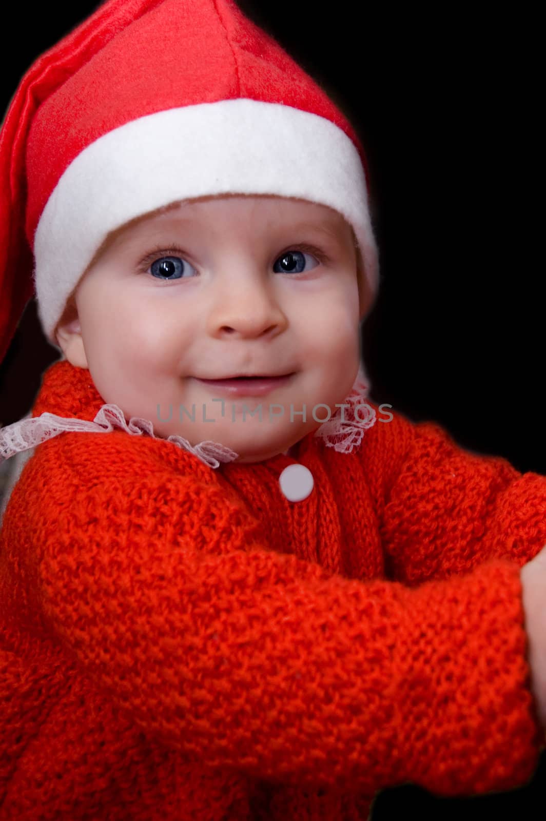 Portrait of baby Santa over black background