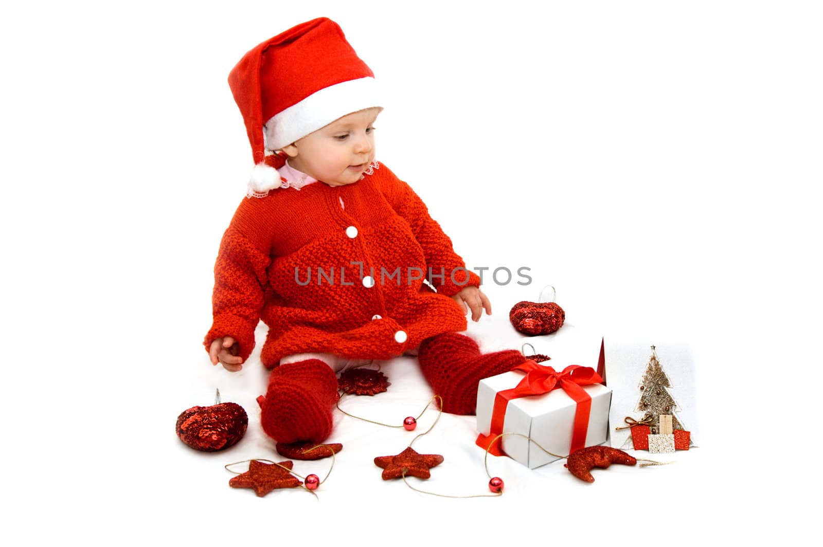 Baby dressed as Santa helper with Christmas decoration