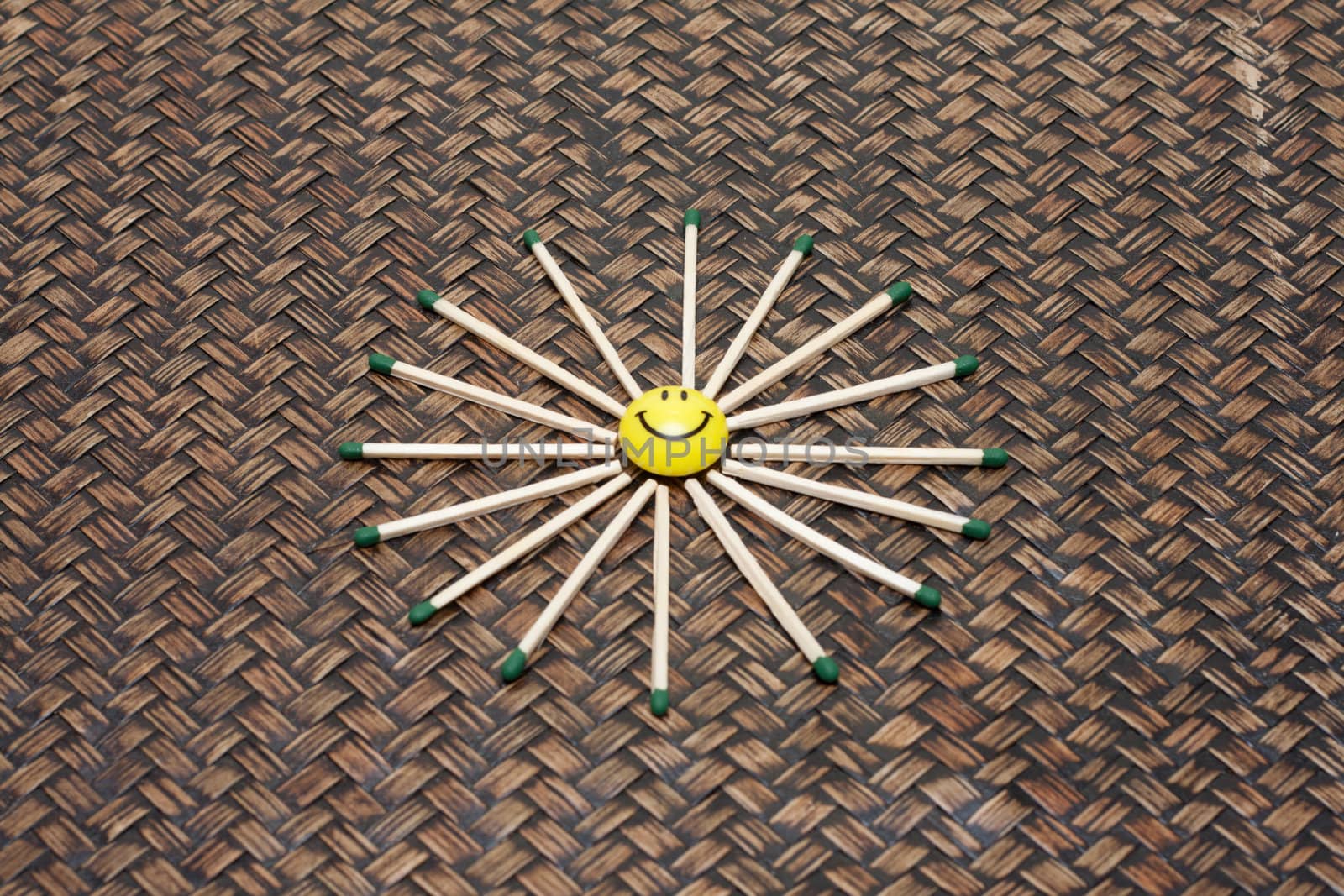 Yellow smile on bamboo background, matches by halo