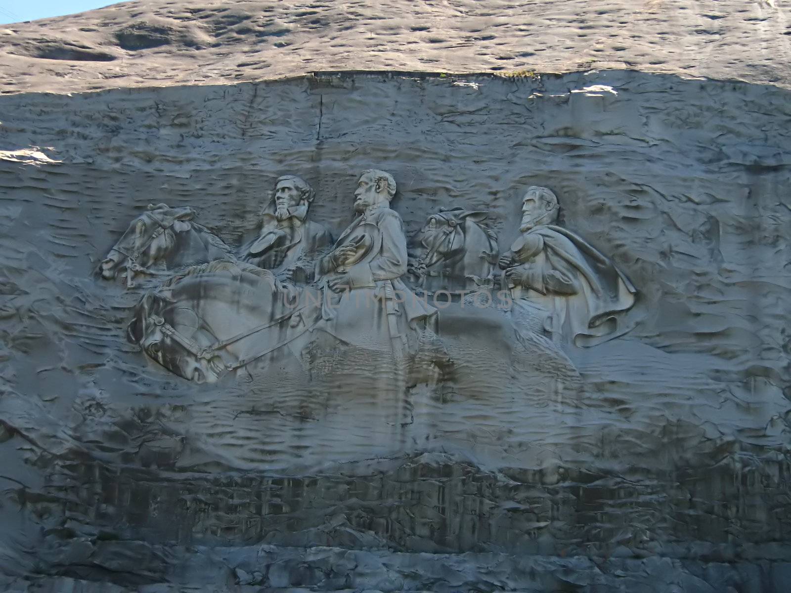 A photograph of the sculpture at Stone Mountain located near the city of Atlanta
in the state of Georgia in the United States. 
This carving is the largest bas relief sculpture in the world and shows Jefferson Davis 
(president of the U.S. Confederacy circa 1861 - 1865) and Confederate Generals Robert E. Lee 
and Thomas Jonathan "Stonewall" Jackson.
