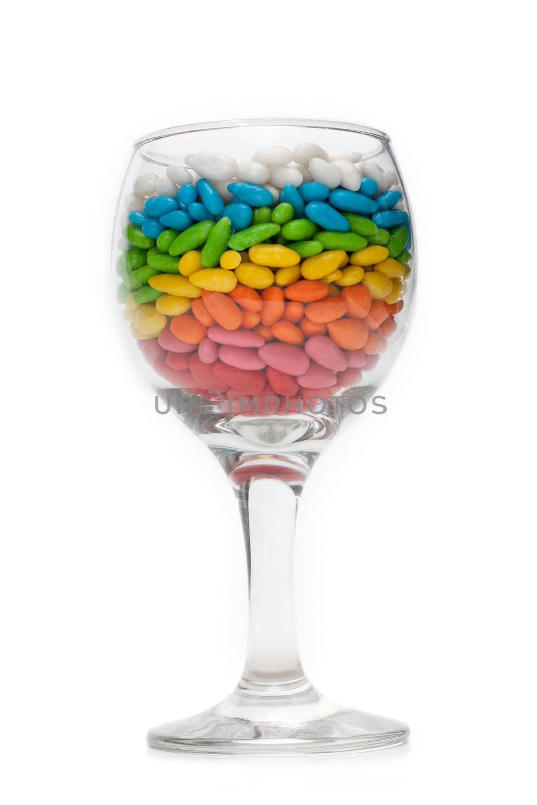 Transparent glasses with colour sweetmeat insulated on white background