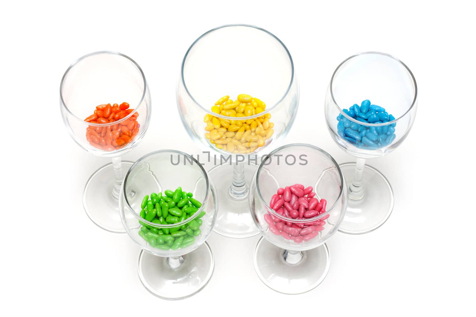 Transparent glasses with colour sweetmeat insulated on white background