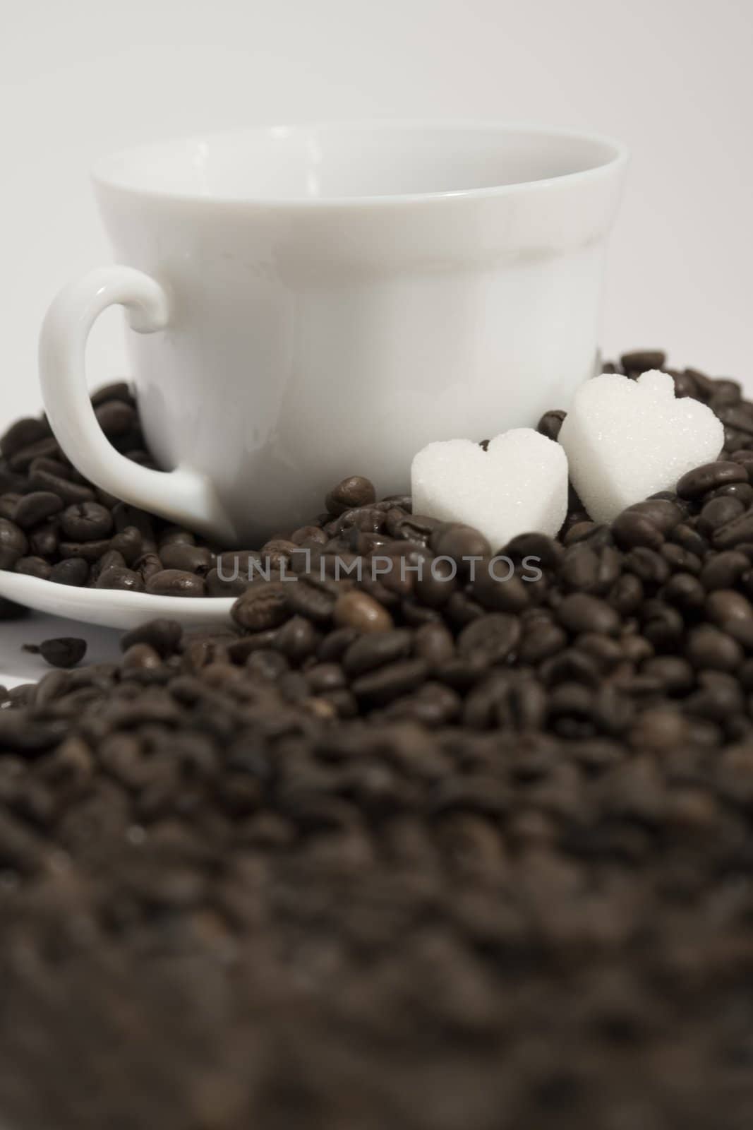 A rich cup of hot coffee, with fresh roasted beans