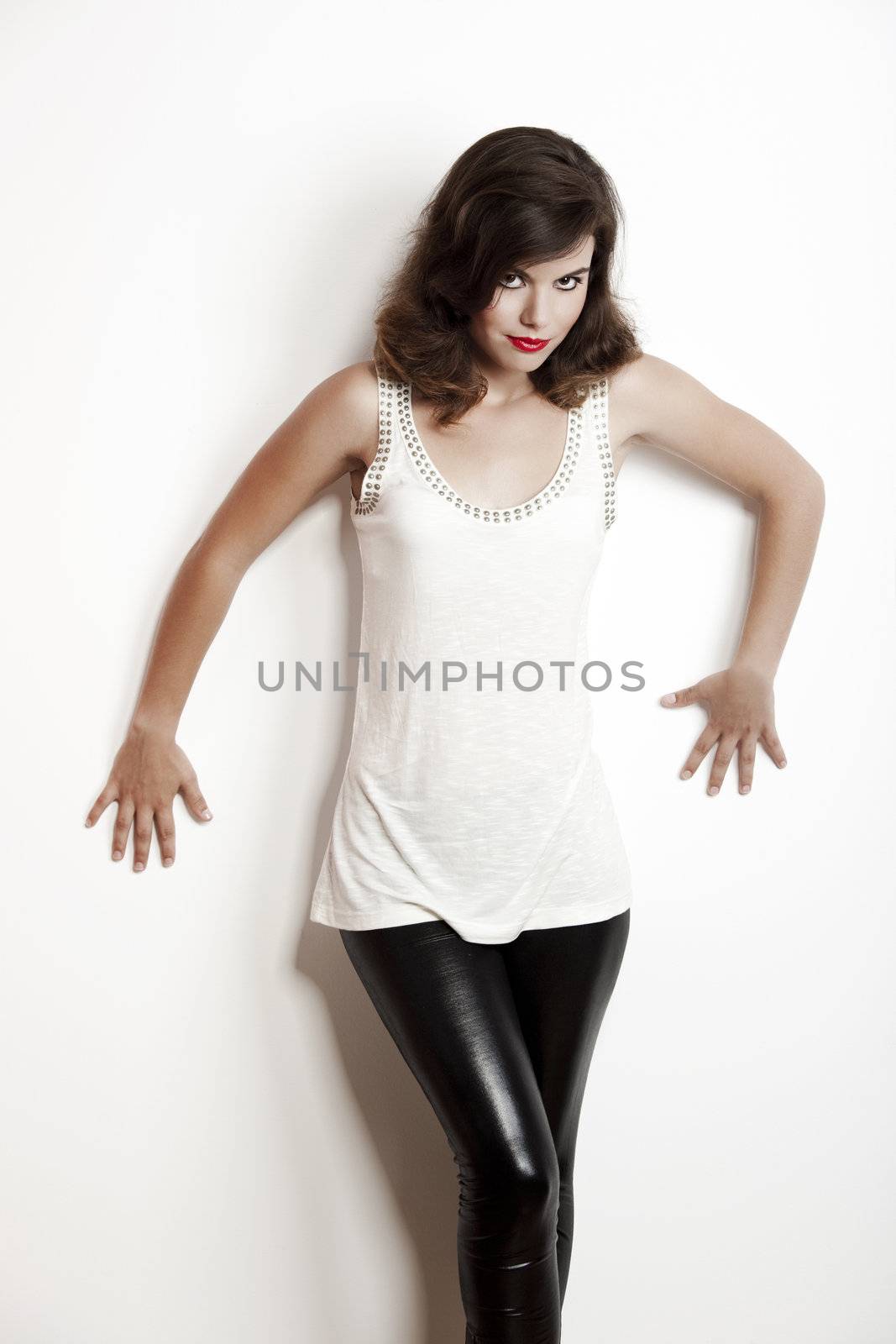 Beautiful and fashion young woman over a white wall