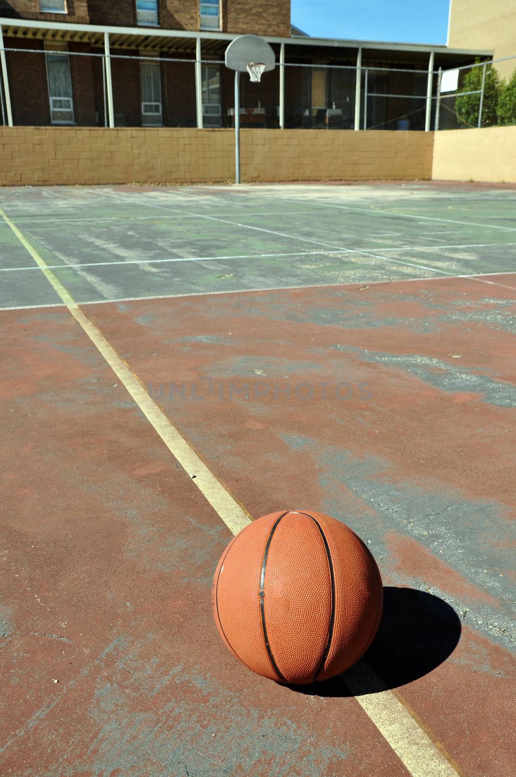 Outdoor basketball court in schoolyard.