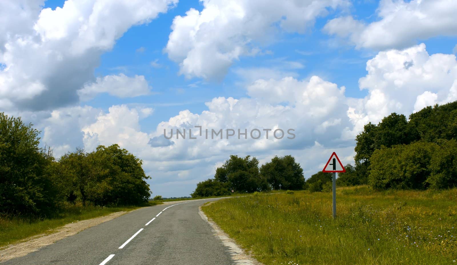 Forest and meadows on both sides of paved roads