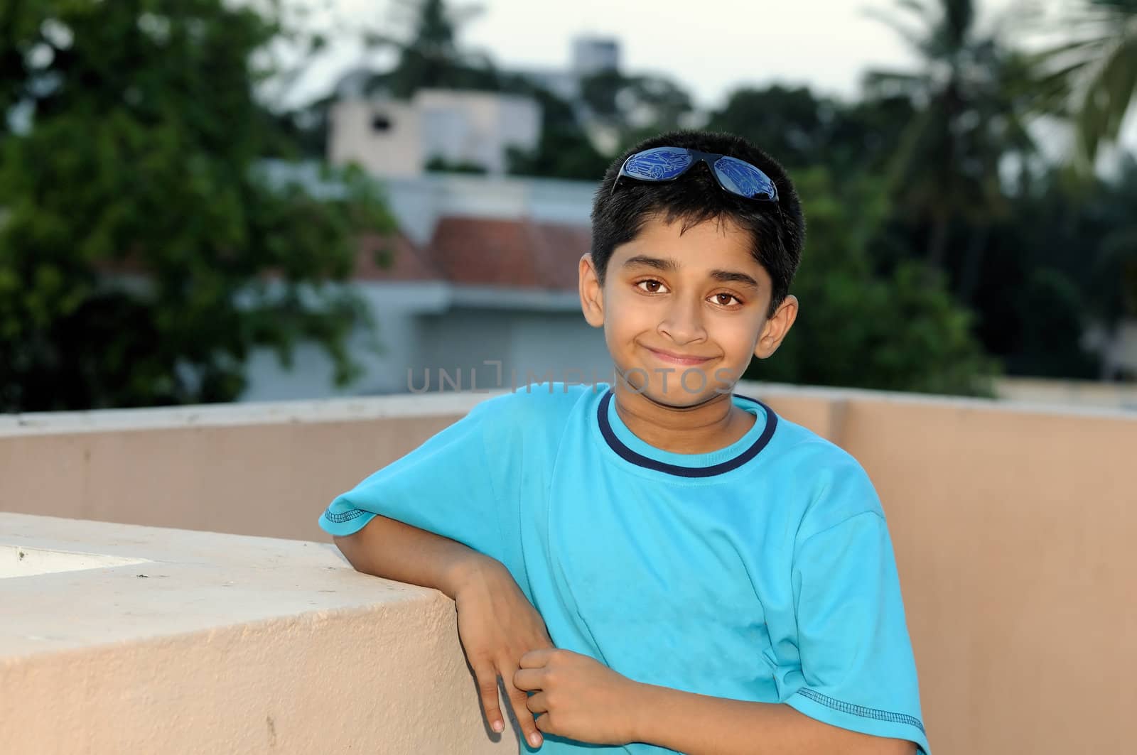 An handsome young Indian kid looking very happy