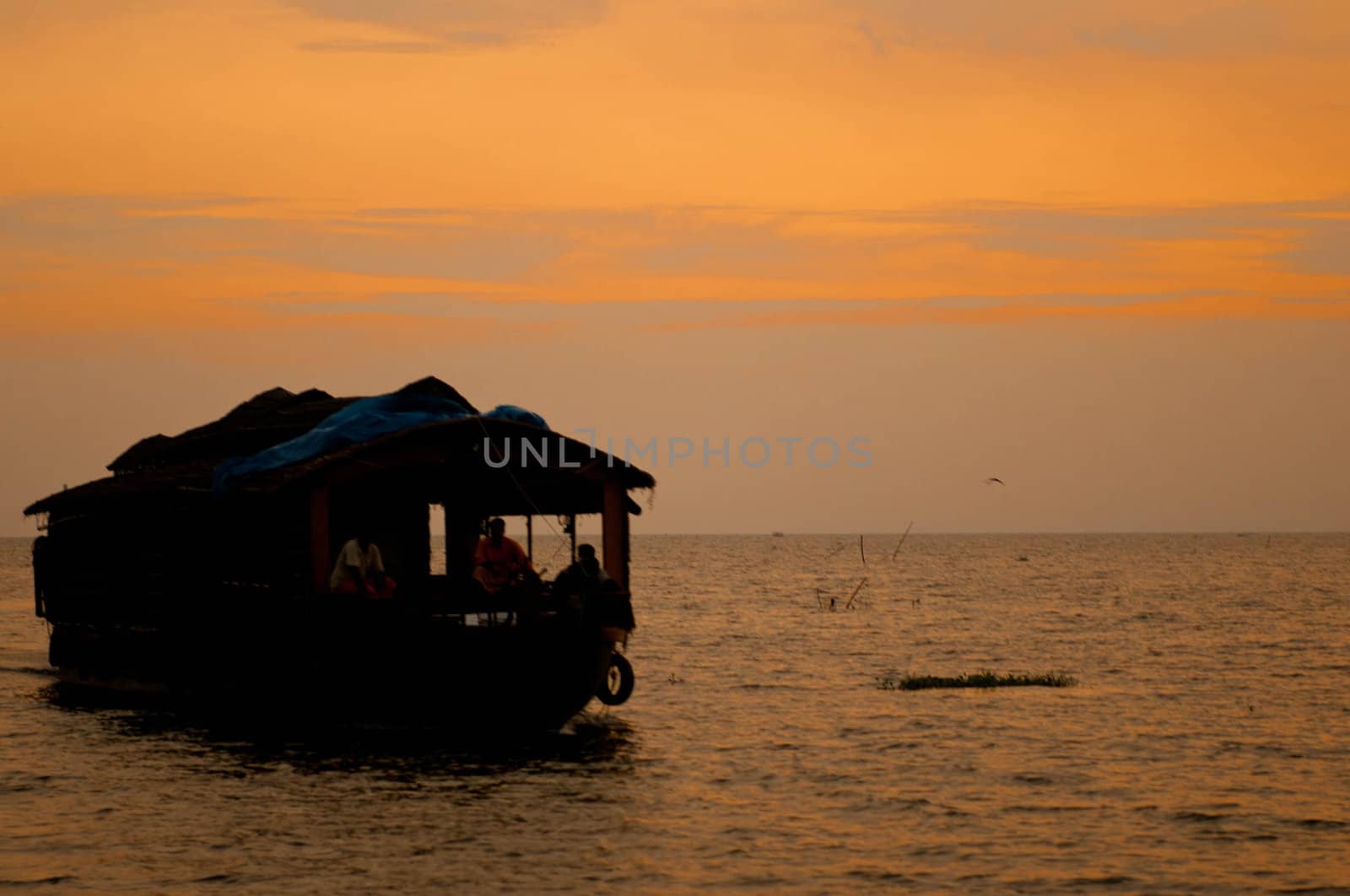 A cozy houseboat sailing during the twilight hours