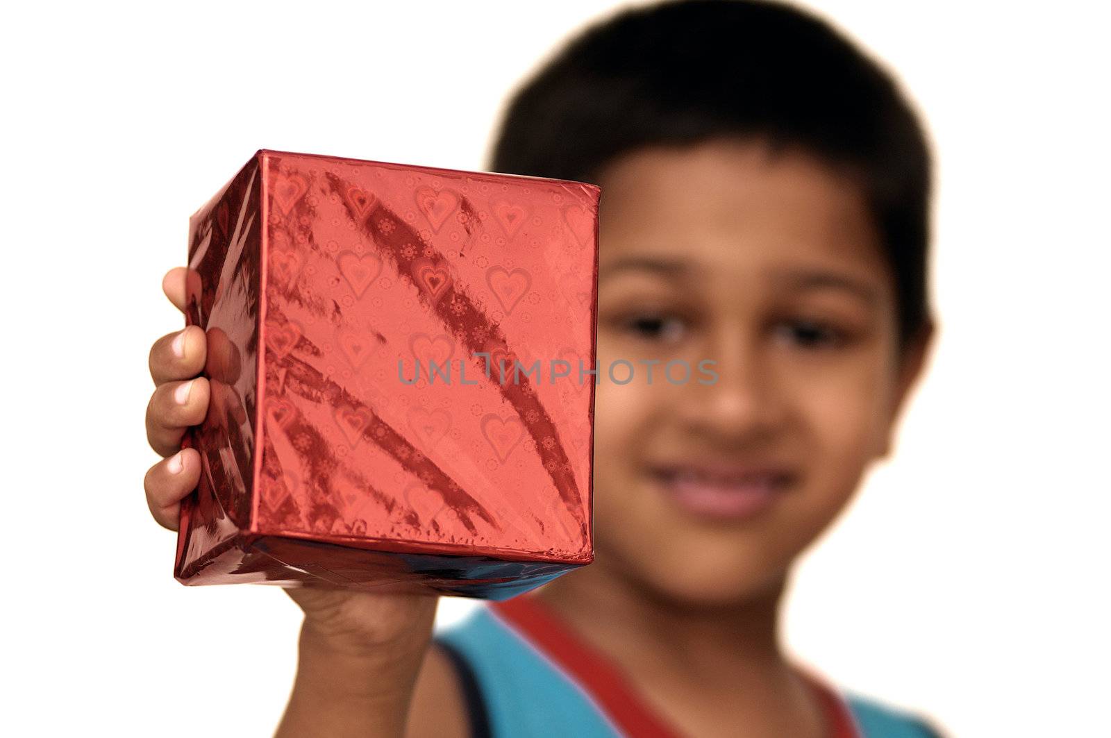An yound Indian kid holding a gift for you