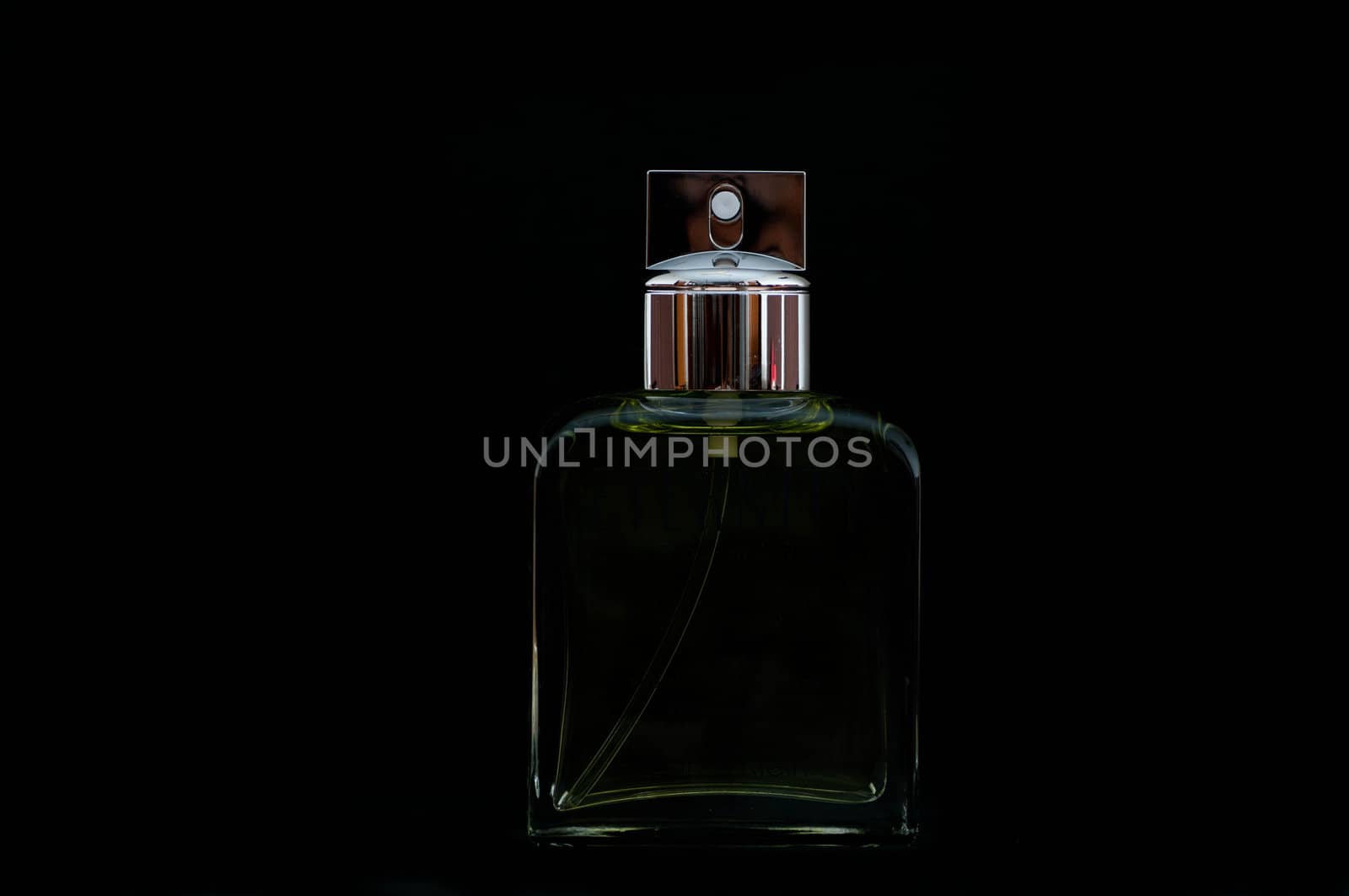 Beautifully and elegantly lit perfume bottle on black