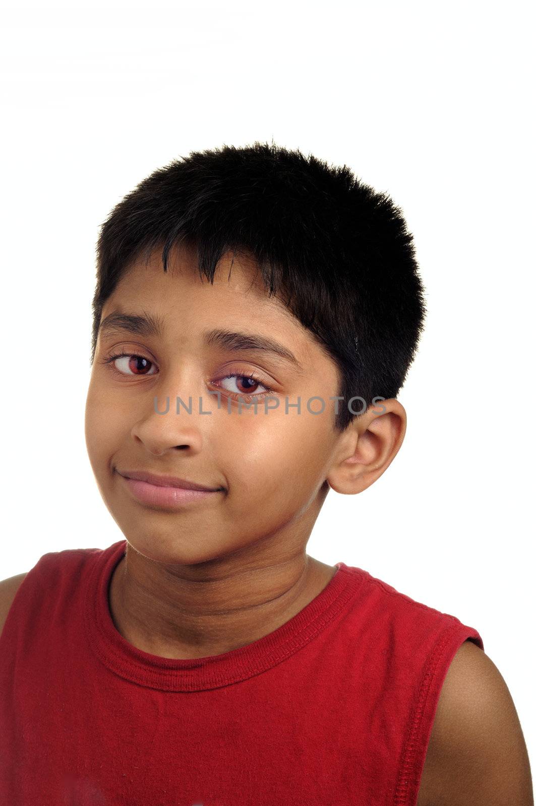 An handsome Indian kid smiling at the camera 