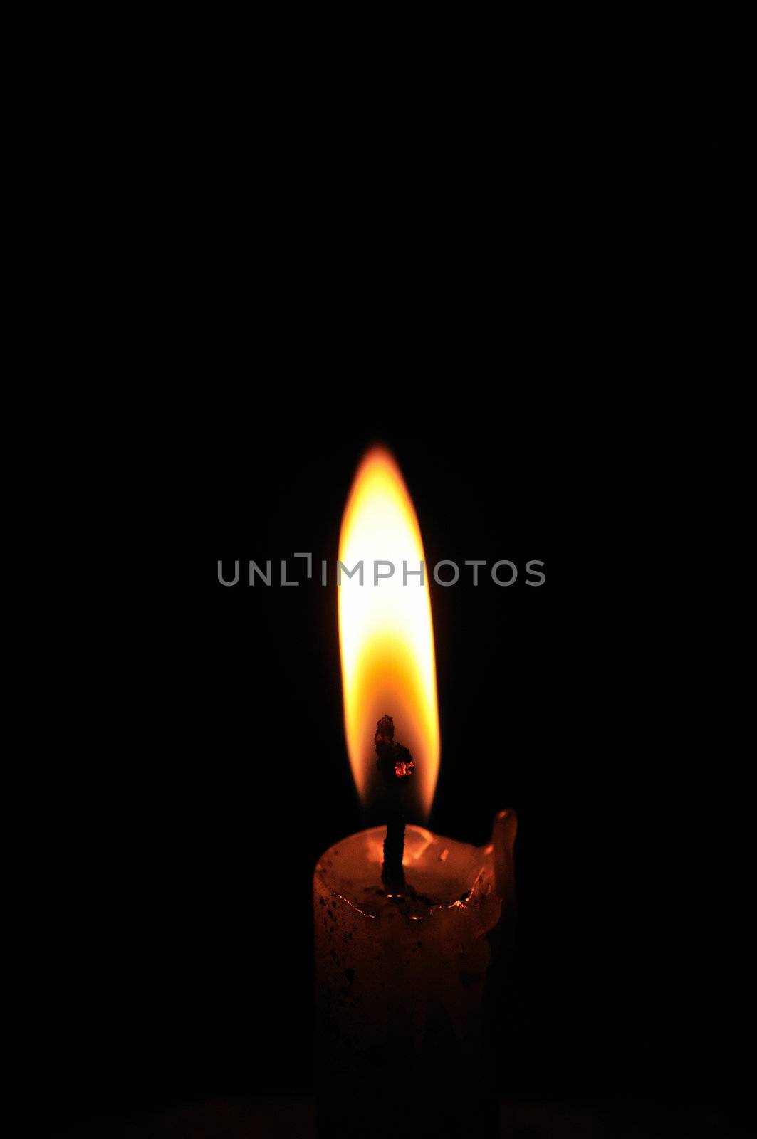 Bright candle isolated on a dark background