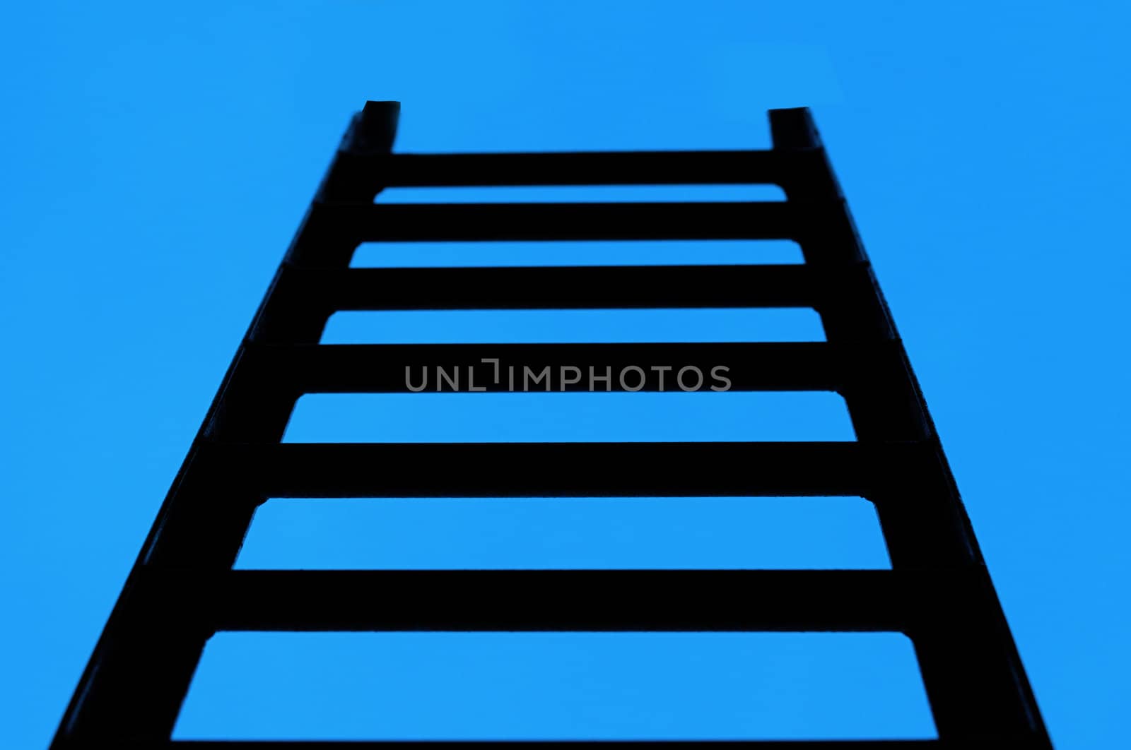 Ladder in the sky. An iron rusty ladder on a background of the blue sky