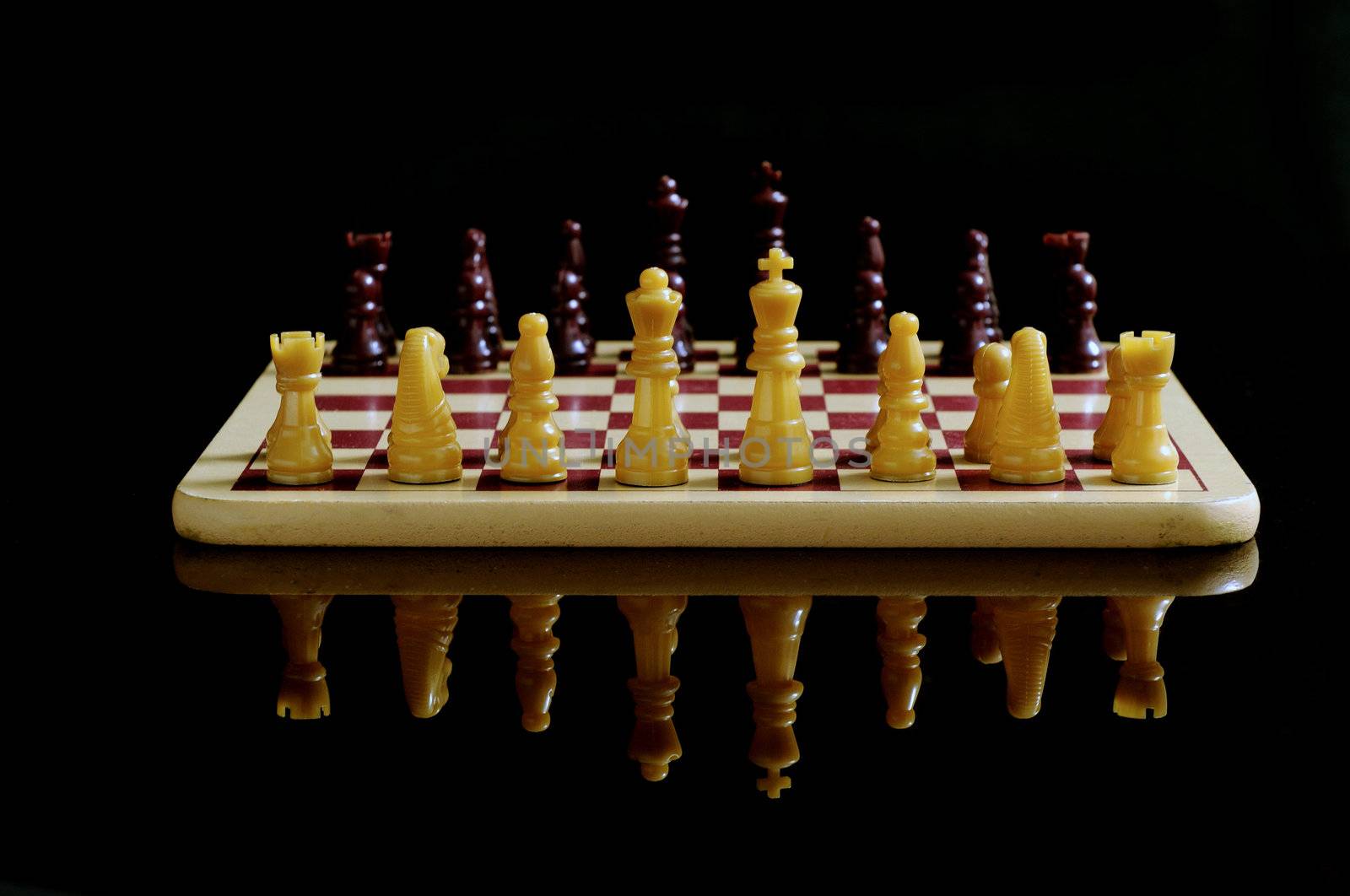 Chess board and coins isolated on a black background 