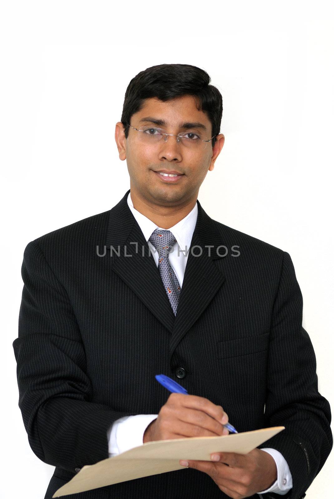 An handsome Indian businessman signing some documents