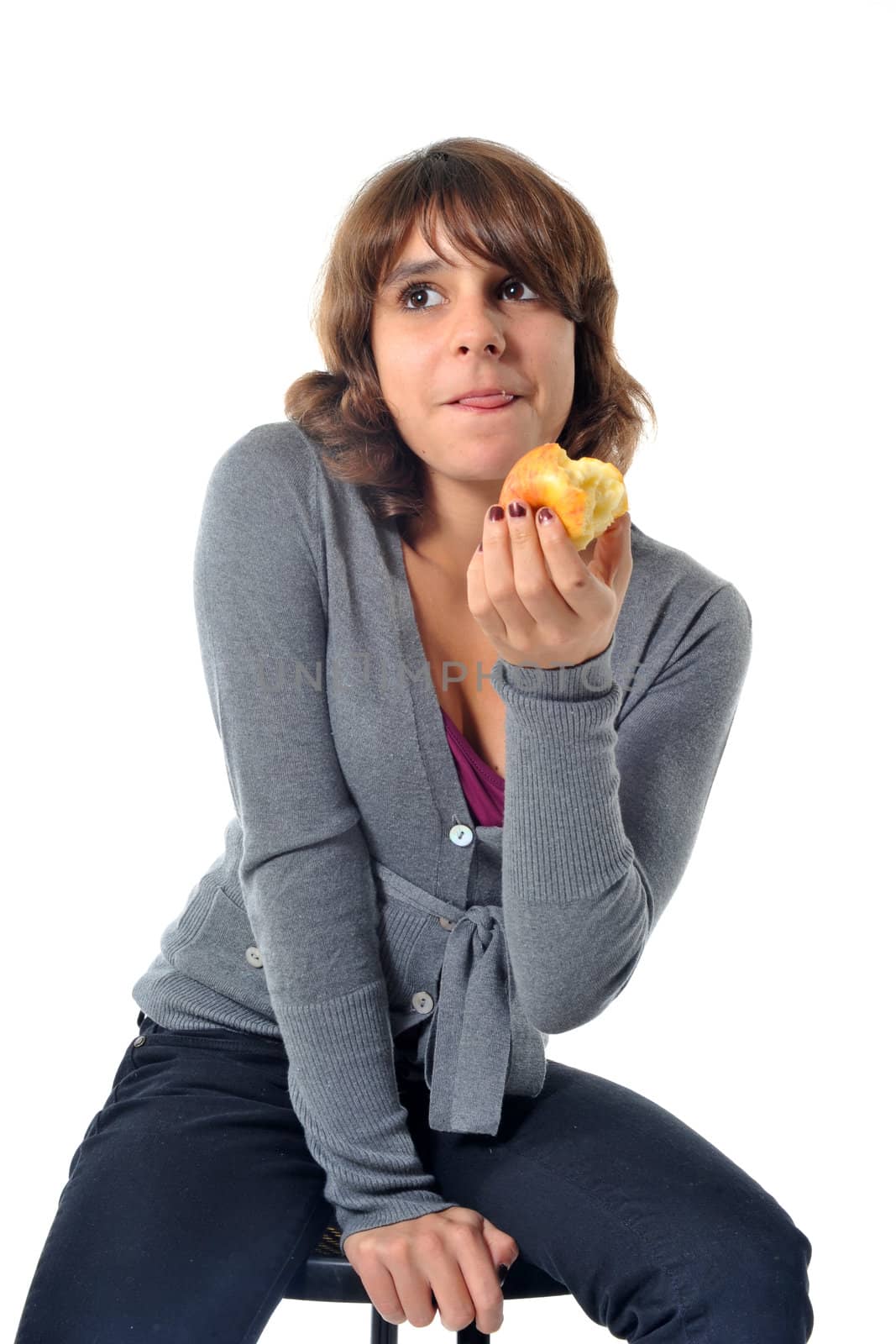 beautiful teenager eating an apple in front of a white background