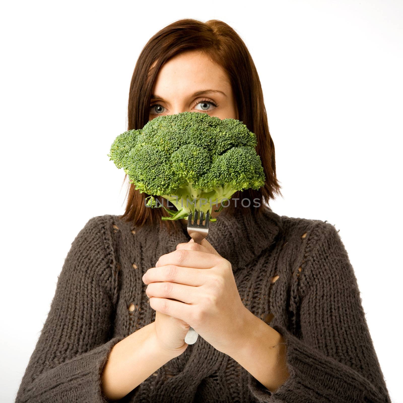 A woman ready to eat broccoli