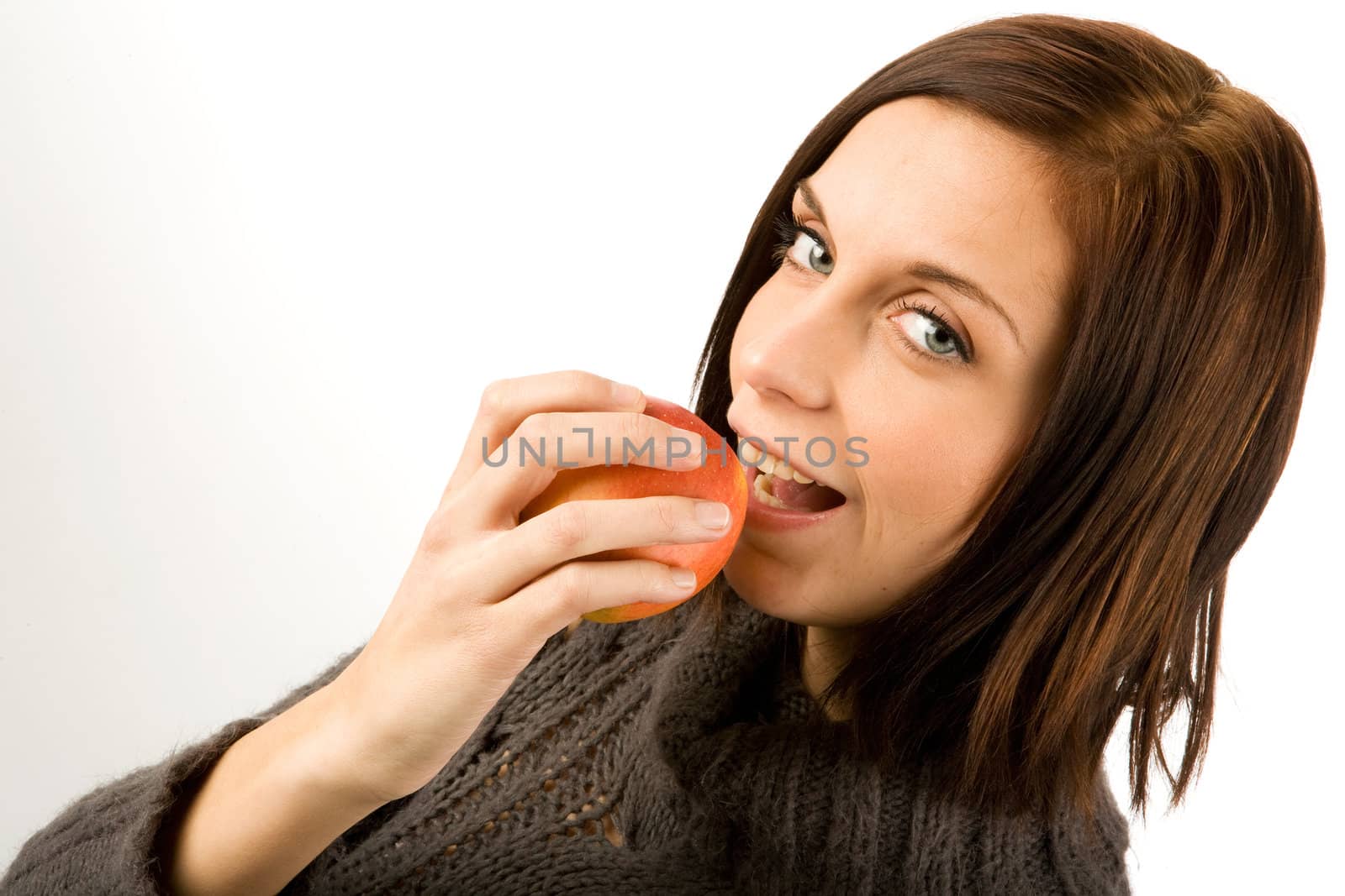 A young woman eating an apple