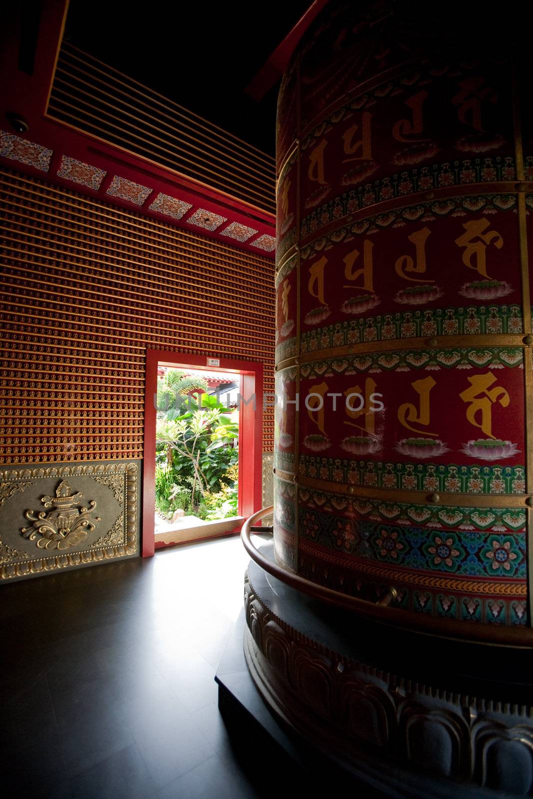Interior of a Buddhist temple with a prayer wheel