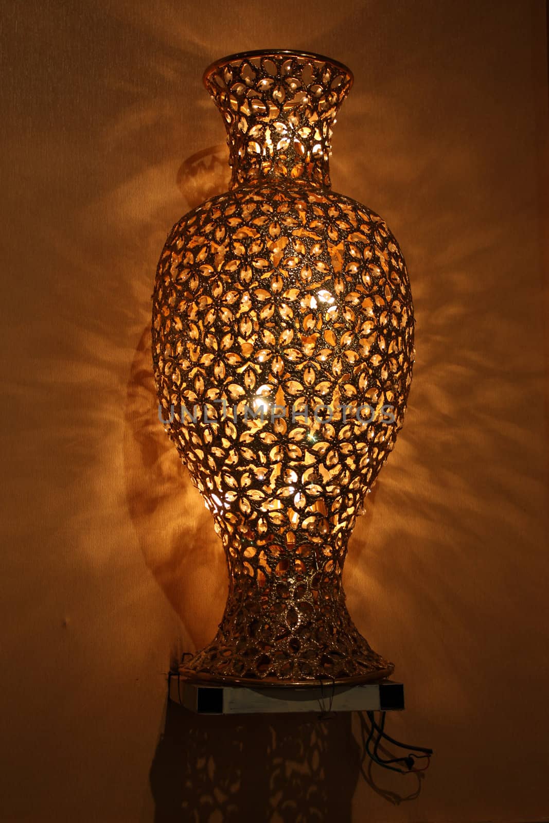 An antique lamp designed in the shape of a flower vase.