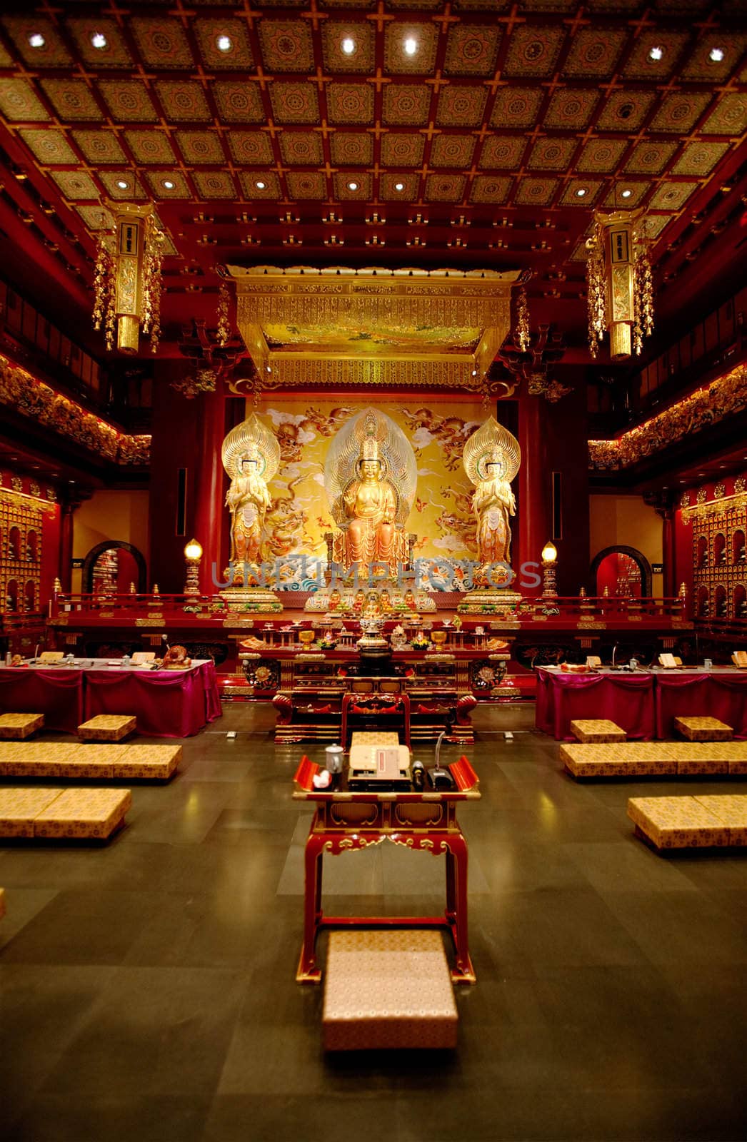 An interior of a Buddhist temple with a Buddha statue