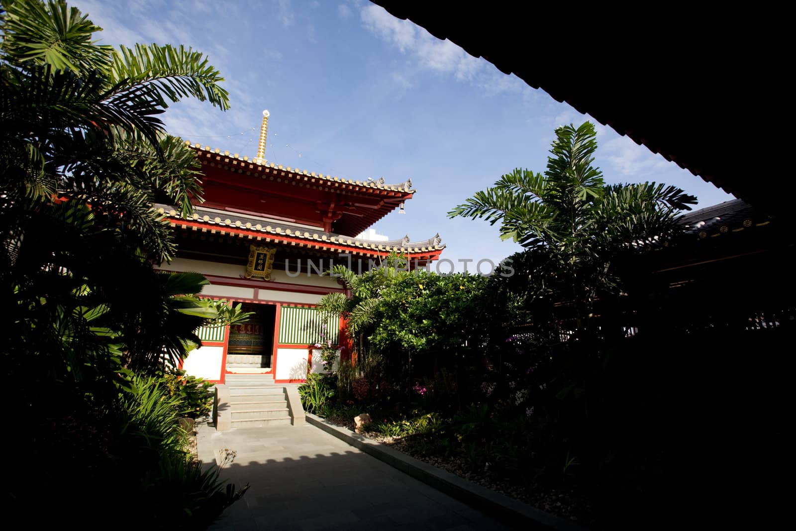 A buddhist temple with a garden and shade