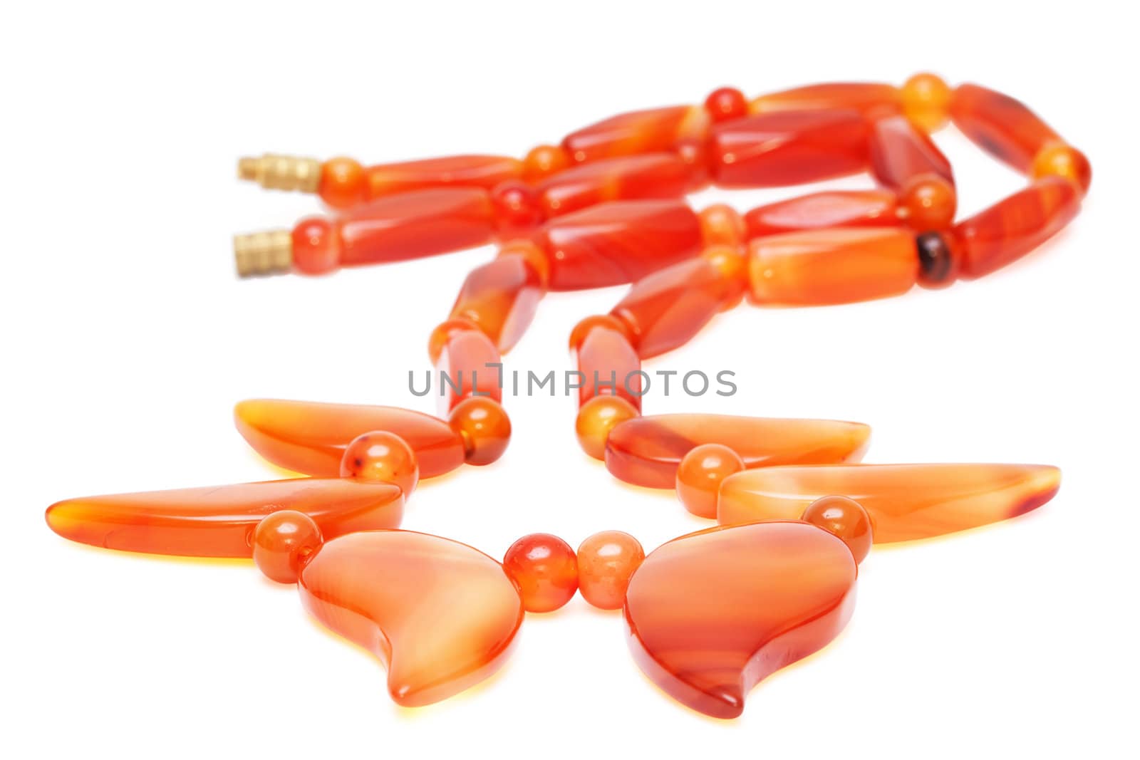 Reddish amber beads isolated on the white background