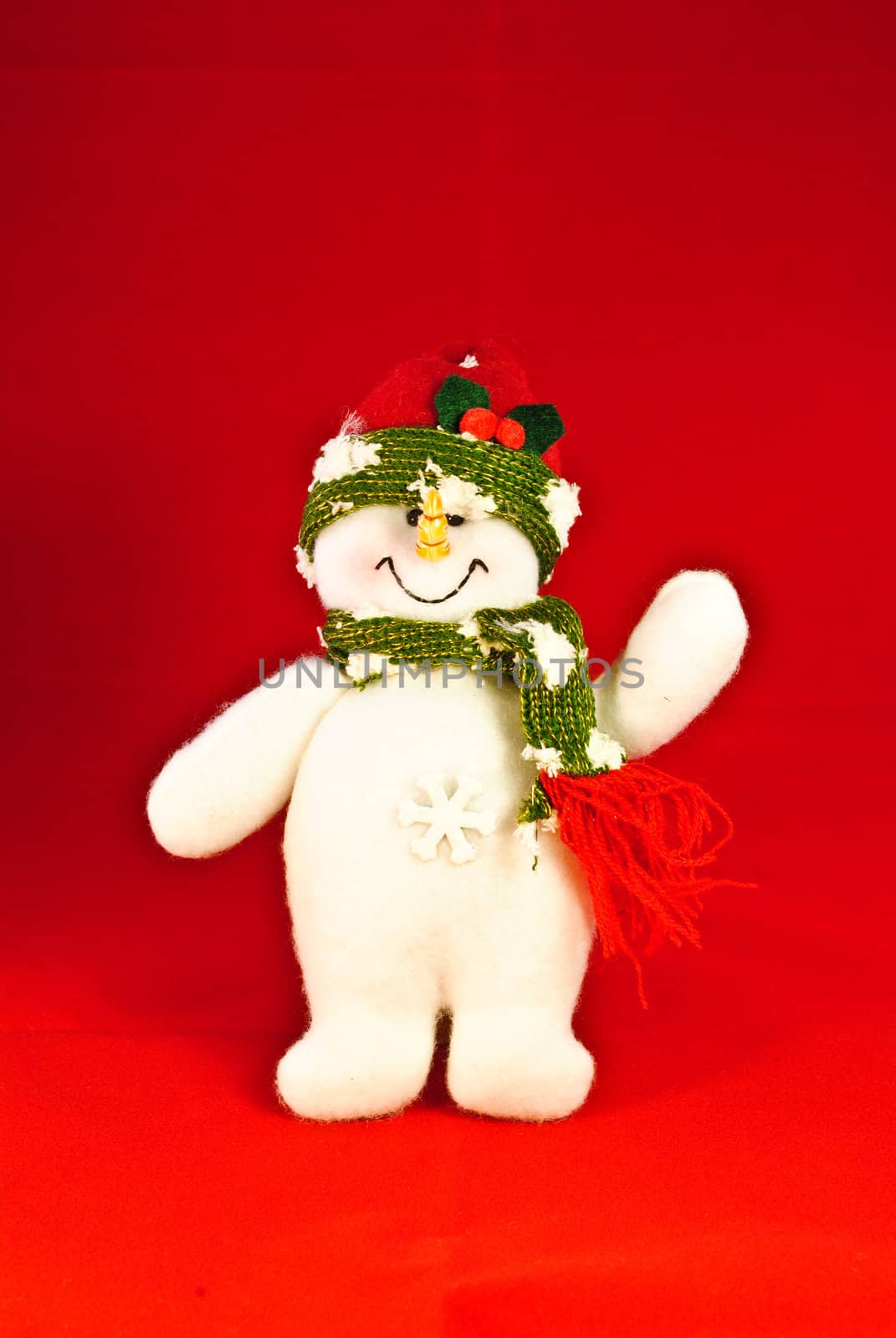 A toy snowman on a red background