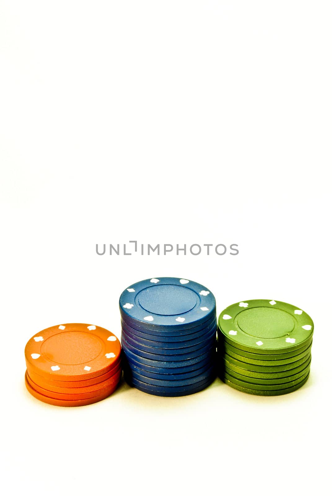 Three stacks of red, blue and green poker chips