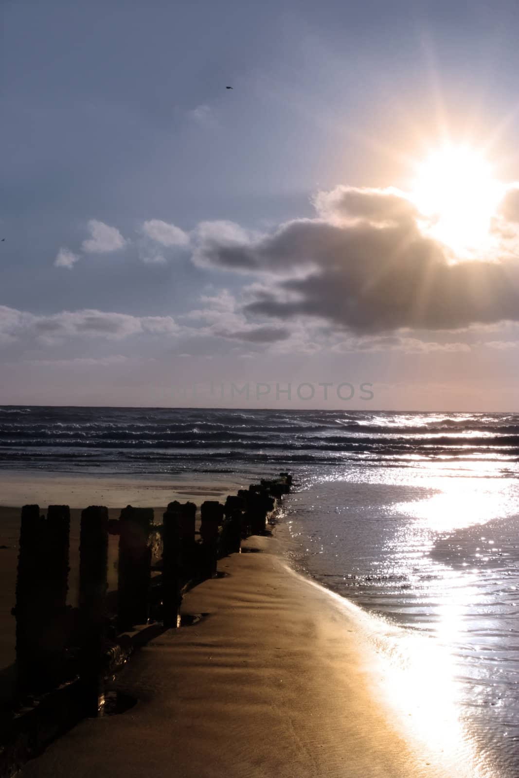 wave breakers at sunset on a beach in youghal county cork ireland
