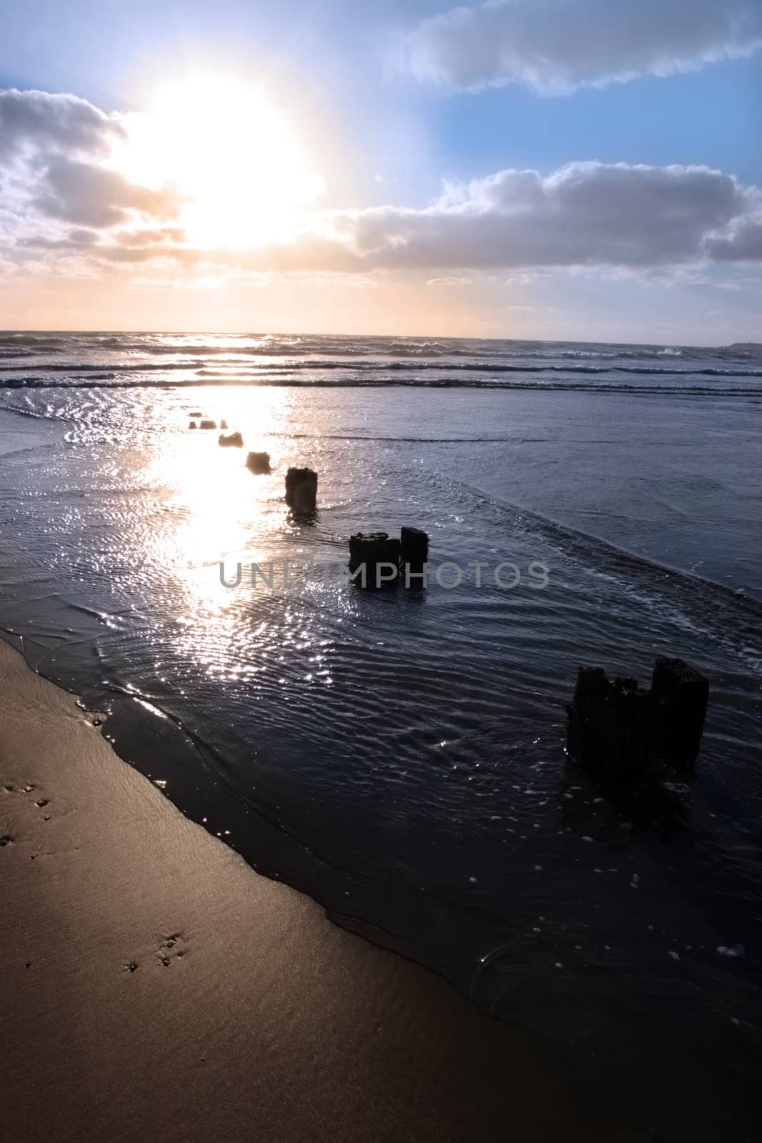 wave breakers at sunset on a beach in youghal county cork ireland