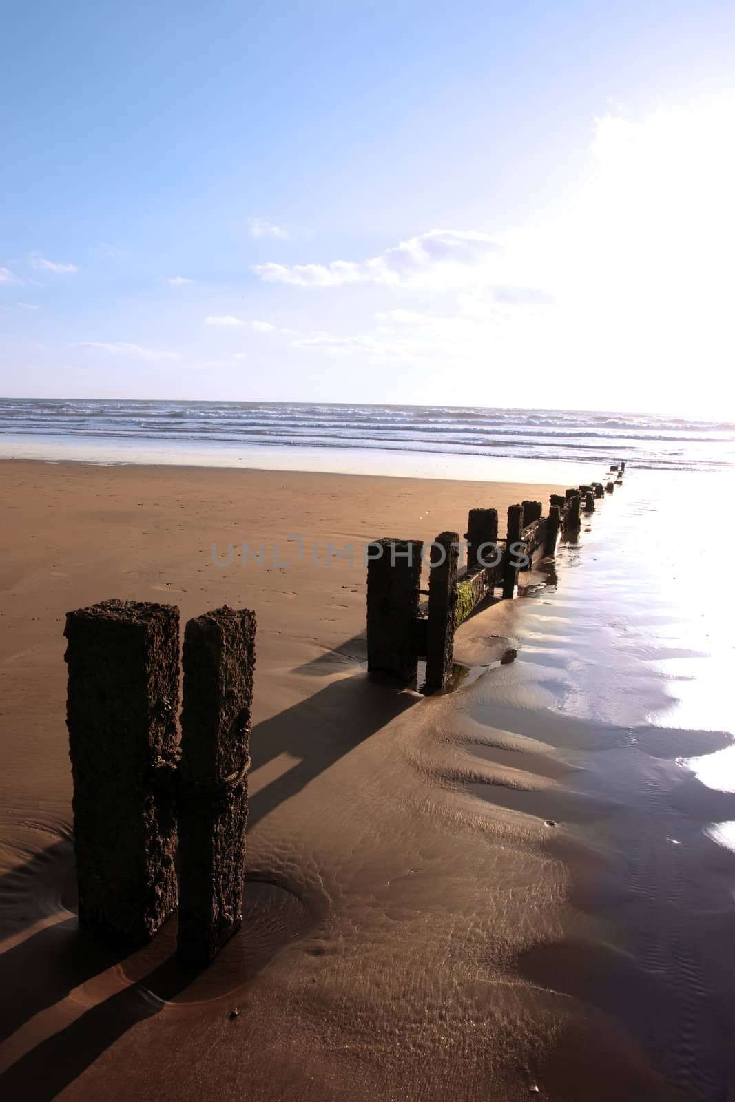 wave breakers at sunset on a beach in youghal county cork ireland