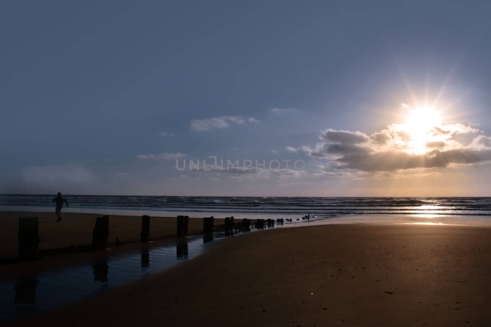 wave breakers at sunset on a beach in youghal county cork ireland