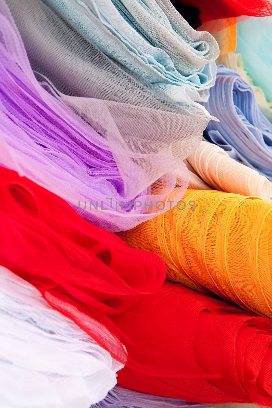 A background of various rolls of cloth