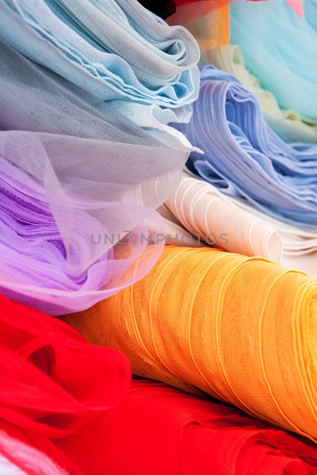 A background of various rolls of cloth