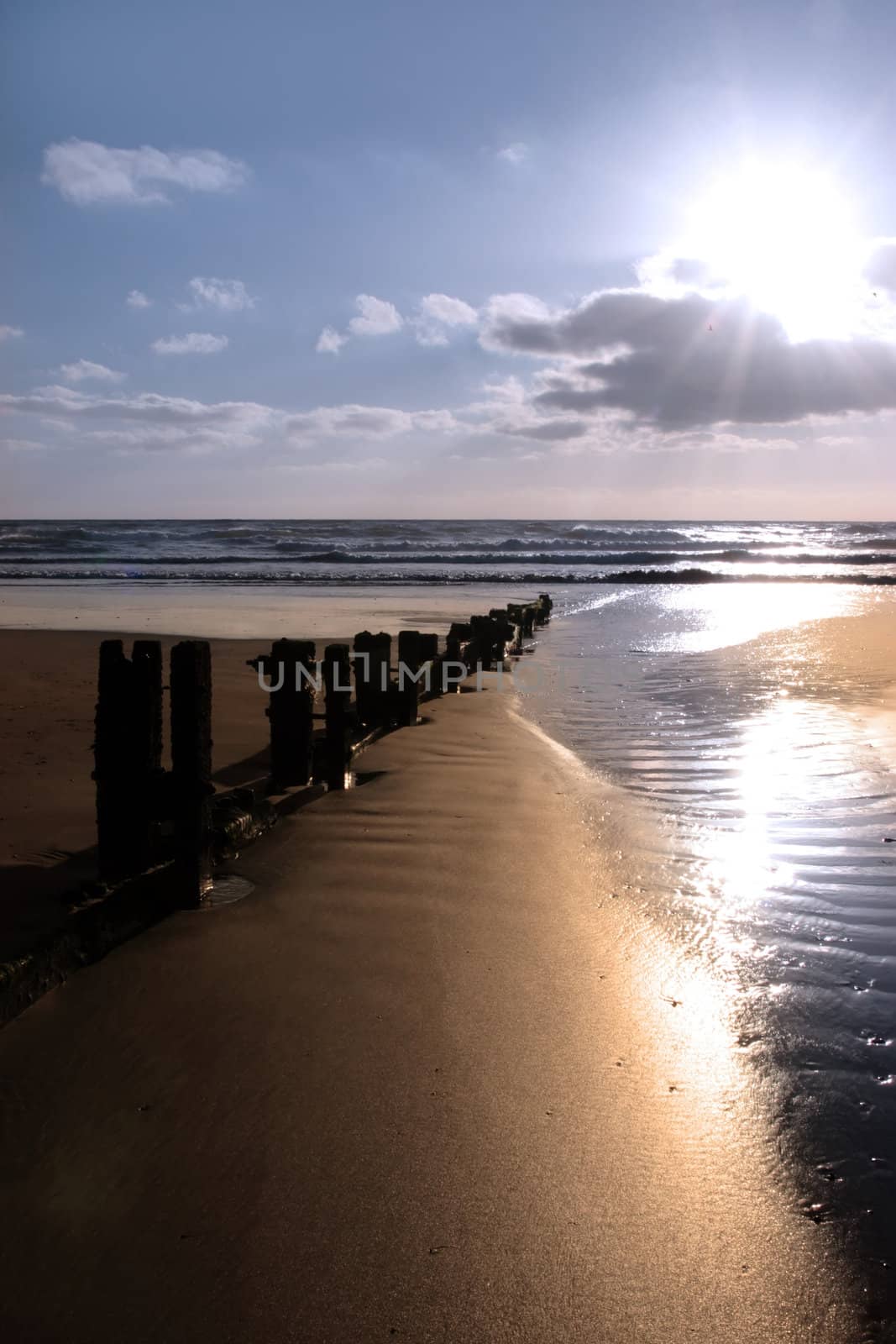 wave breakers at sunset on a beach in youghal county cork ireland