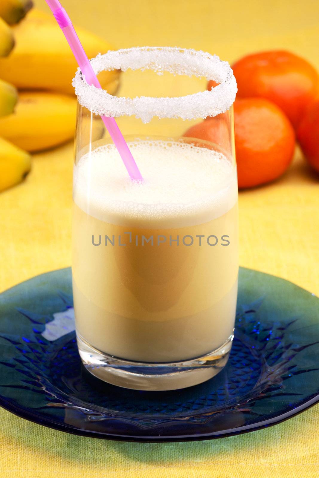 A smoothie made from oranges and bananas in an elegant glass