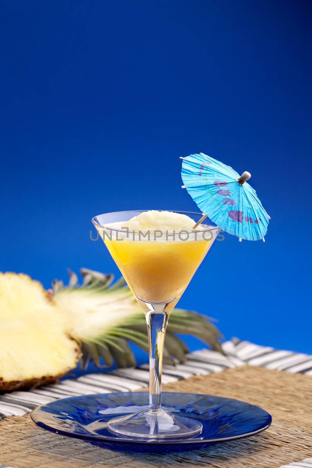 A pineapple smothie isolated over blue