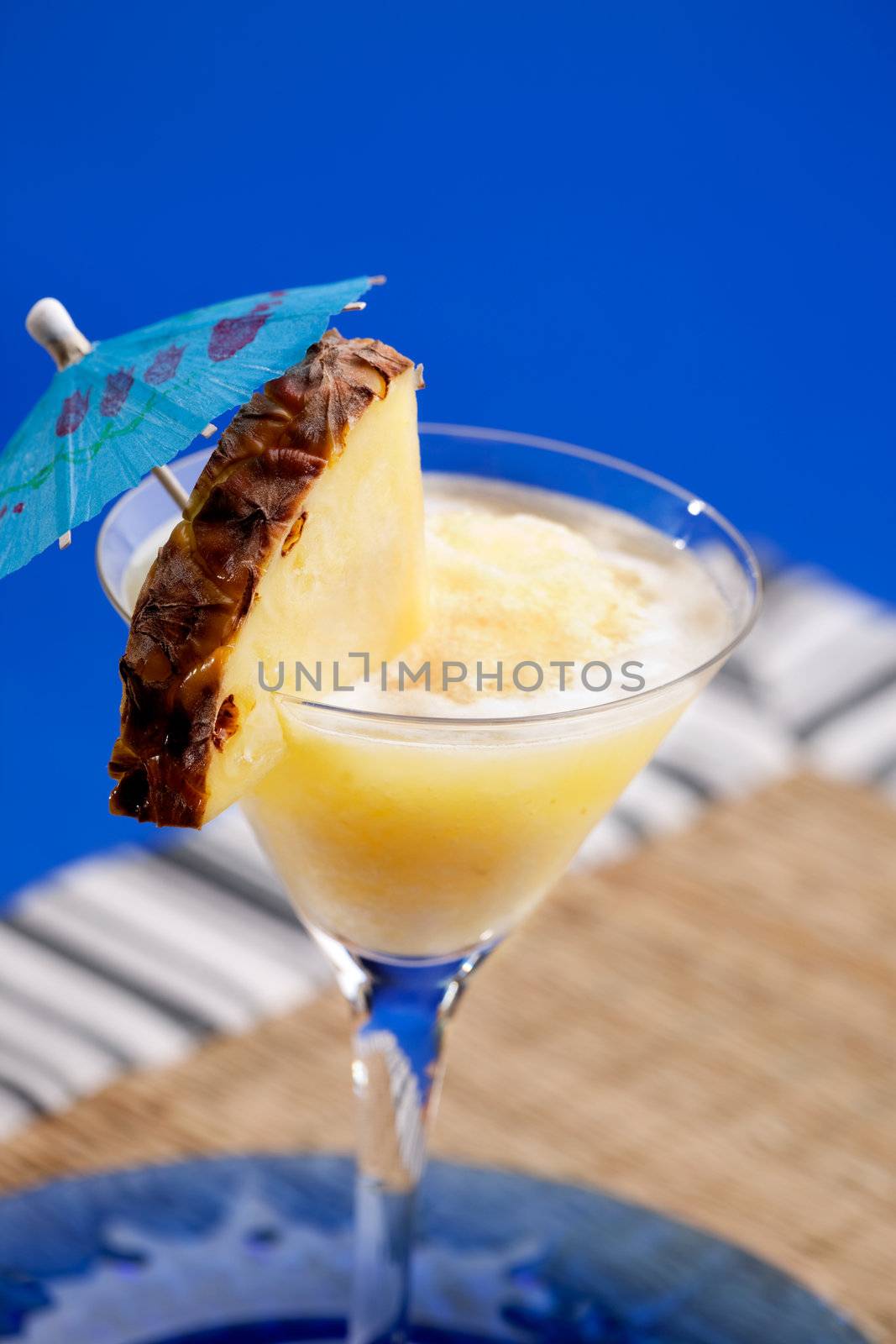A pineapple pina colada smothie isolated over blue