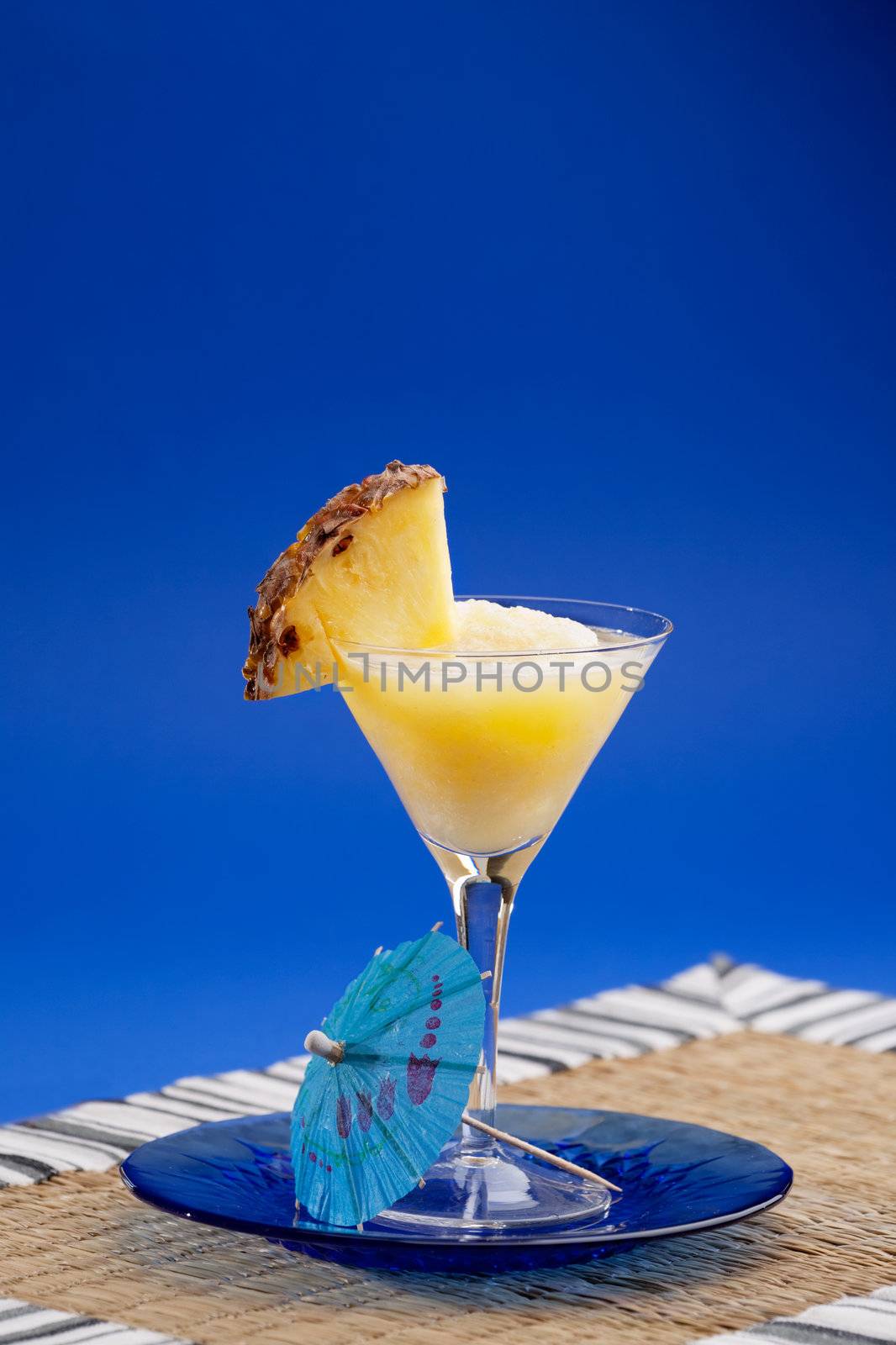 A refreshing summer drunk - pina colada over a blue background
