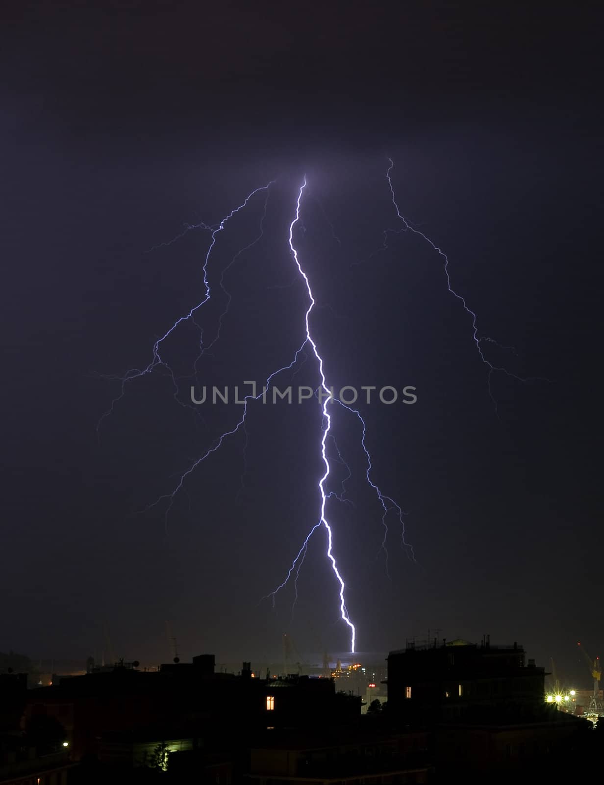 Lightning into the sea during a storm near the port of Genoa, Italy