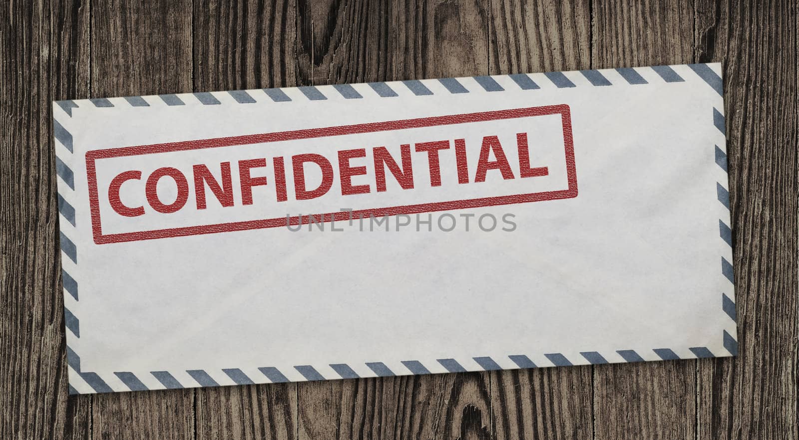 Confidential  envelope on wooden background, clipping path.