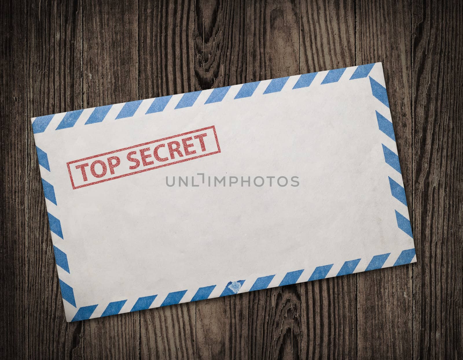 Open  envelope with top secret stamp, on wooden table, clipping path. 